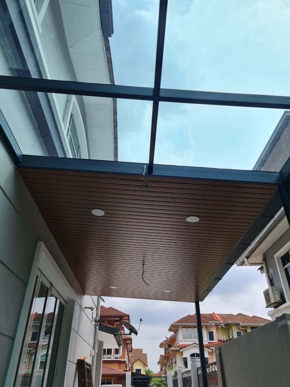 Completed awning with aluminium strip ceiling and glass roof panels