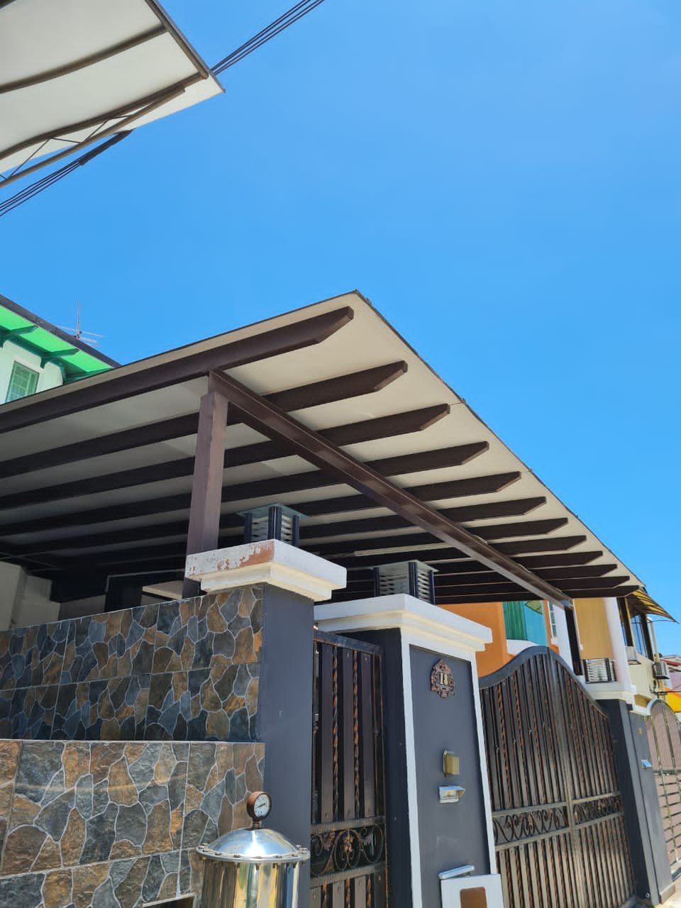Aluminium composite panel roofing awning above a home entrance